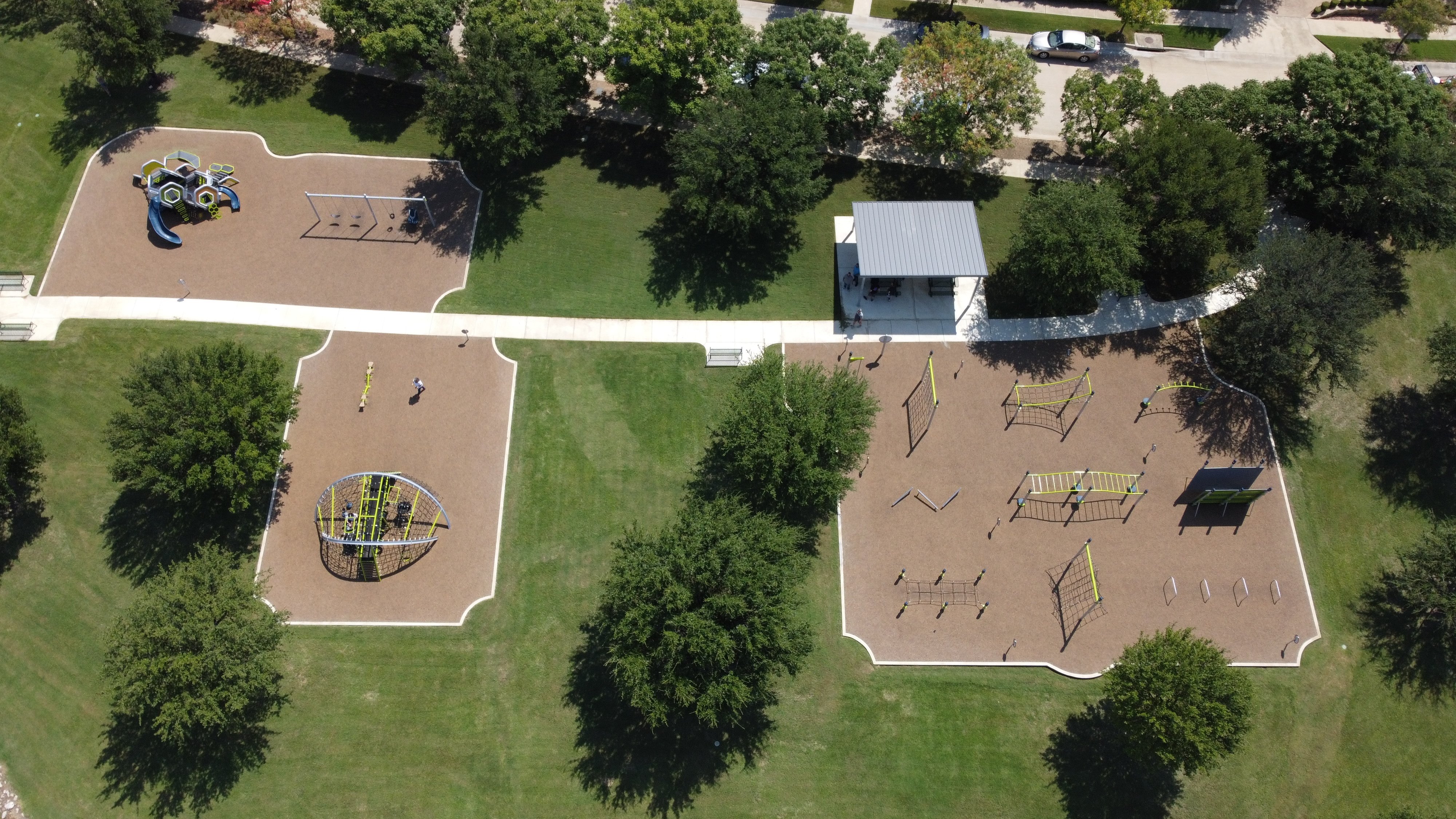Fitness park in Castle Hills with playground and site amenities and shade structure.