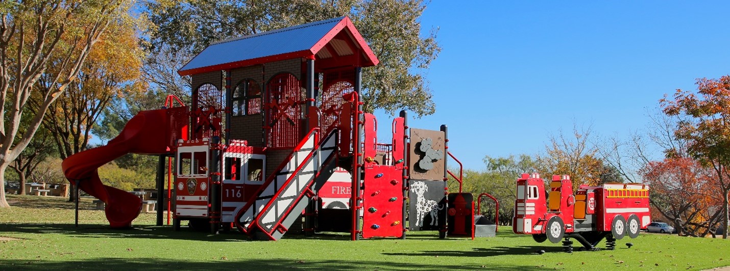 Firefighter-themed play area in Harold K. Bessire Park encourages imaginative and educational play.