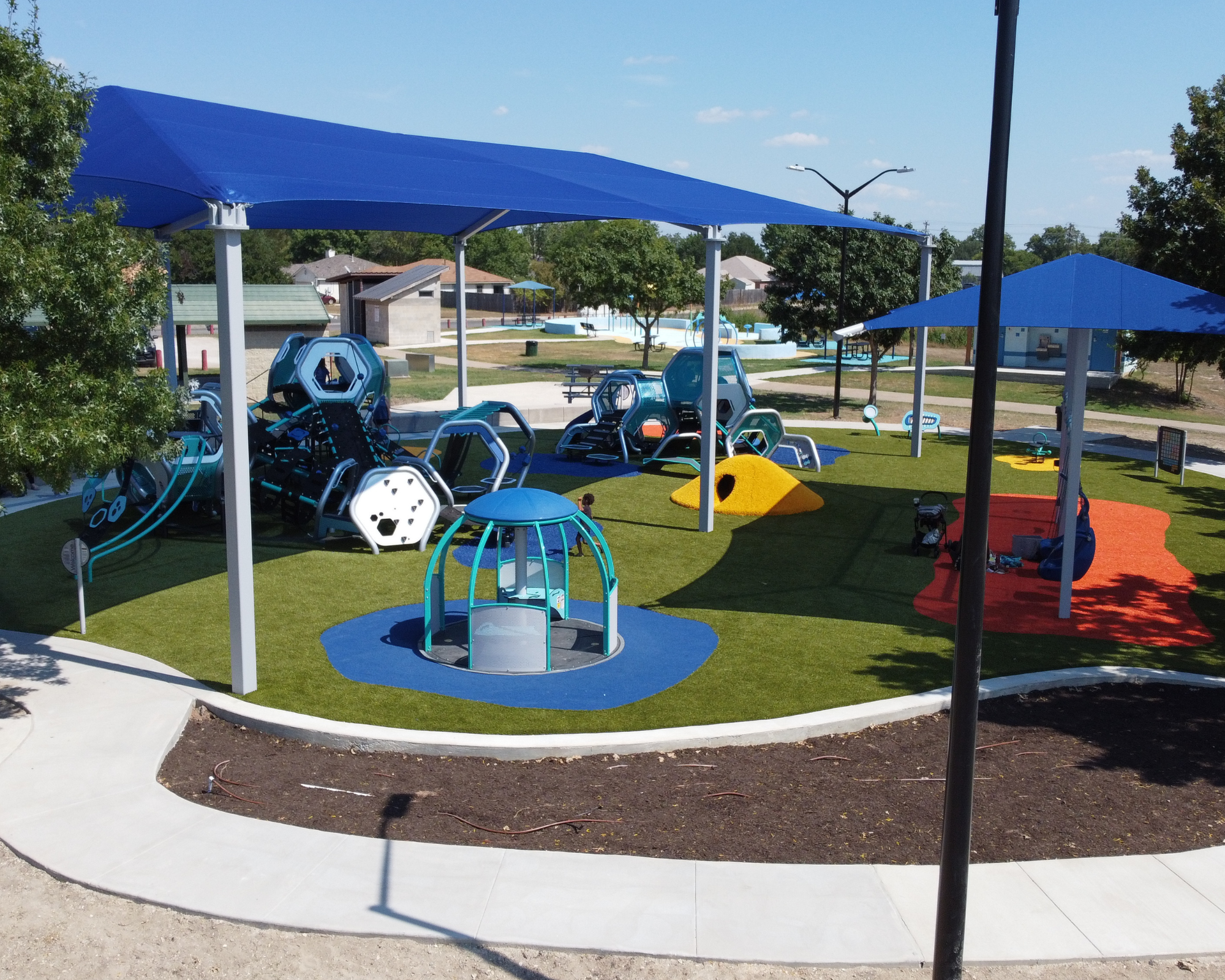 Family playground design and construction in Kyle Texas featuring Hedra structures