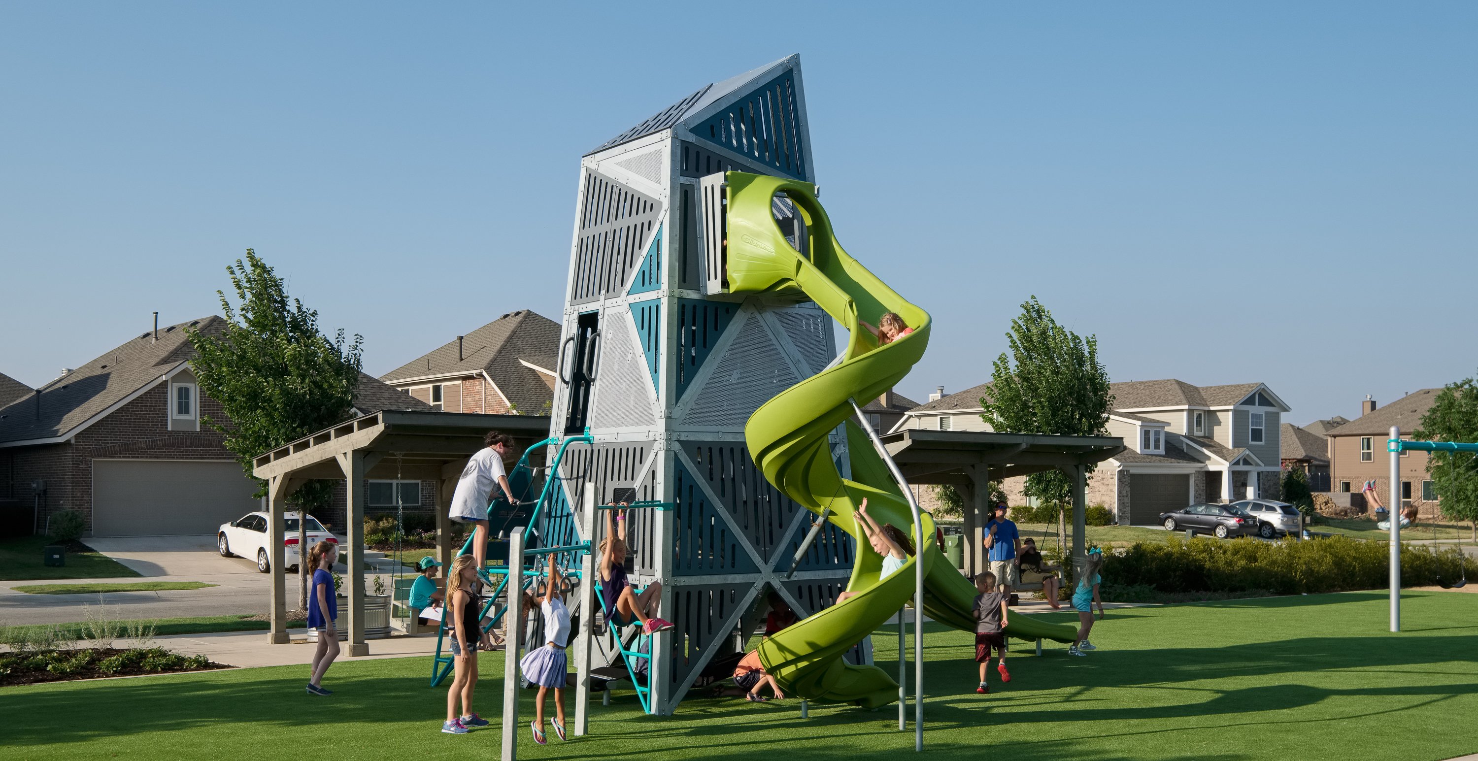 Kids playing, climbing, and sliding on playground equipment