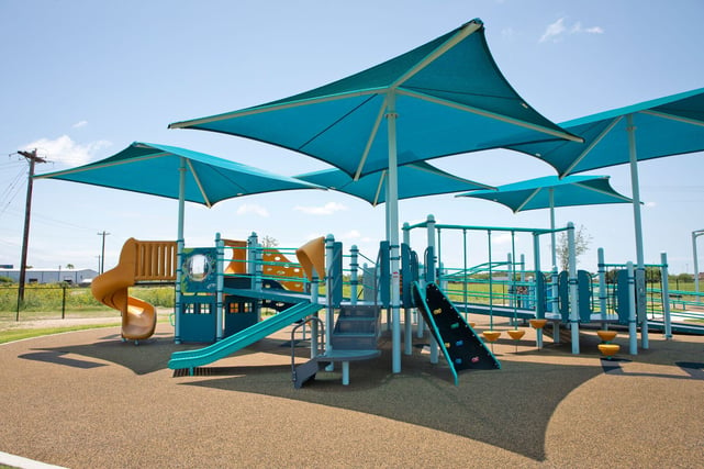 Fabric shade structures over school playgrounds and fields create cooler, safer environments for students and staff.