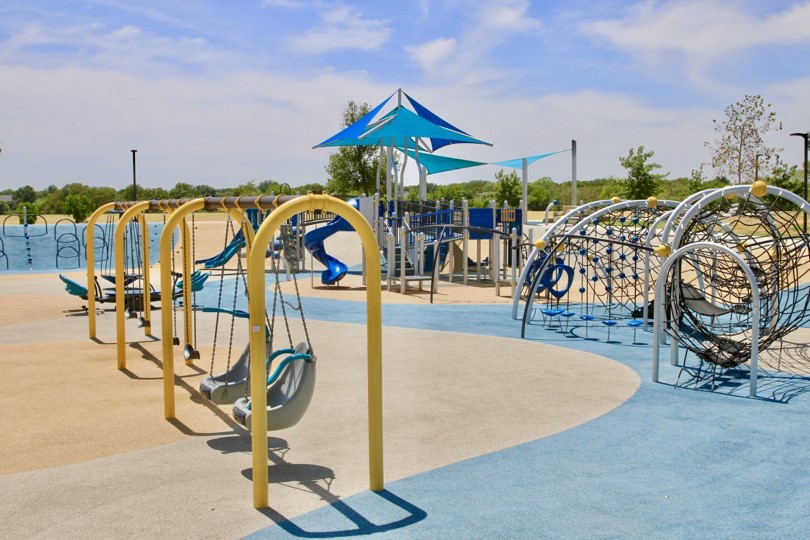 Inclusiveness at Windhaven Meadows Park: Varied swings ensure an inviting playscape for all children.