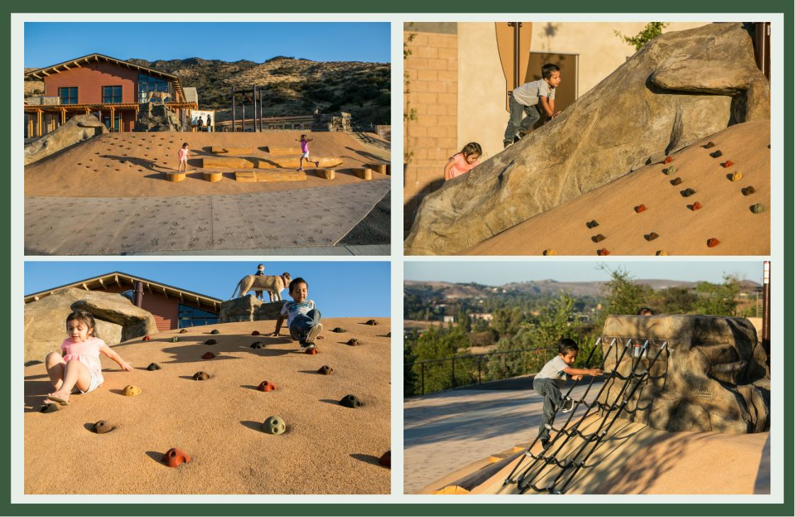 Children climbing sloped, sand-colored hills with embedded handholds, rock-textured boulders and a rope net, showing how topography creates open-ended play.
