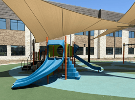 Argyle South Elementary School's exceptional playground offers two age-specific areas, fully covered by shade structures, with GFRC play events and PIP safety surfacing, ensuring a safe and fun environment for kids of all ages in Argyle, Texas.